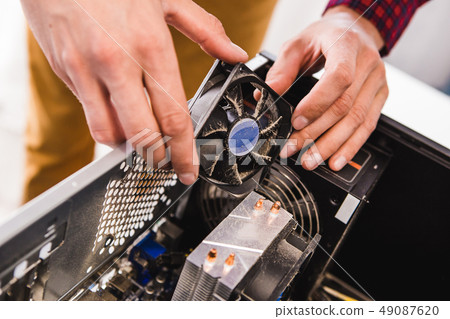 Man examines laptop PC clean dust pollution 49087620
