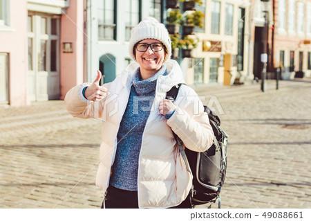 Portrait of a young Caucasian European woman tourist in glasses for the view of a white hat and a Portrait of a young Caucasian European woman tourist in glasses for the view of a white hat and a 49088661