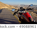 Red motorbike on the road in Negev desert,Israel 49088961