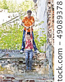 Father and son are playing through ruins 49089378