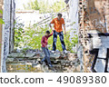 Father and son are playing through ruins 49089380