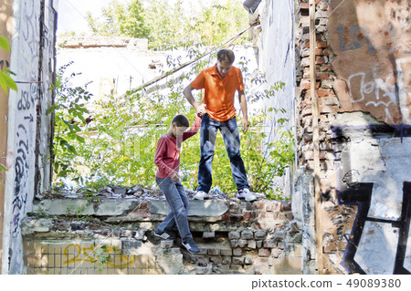 Father and son are playing through ruins Father and son are playing through ruins 49089380