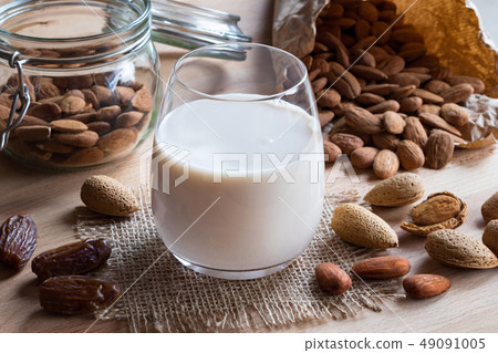 A glass of almond milk with almonds and dates 49091005