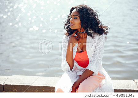 fashionable black girl in a park fashionable black girl in a park 49091342