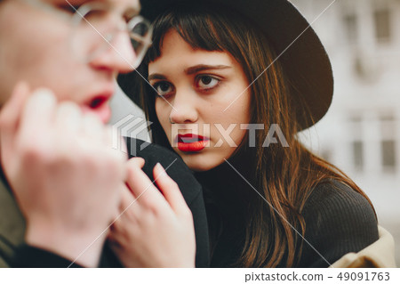 A trendy couple in a gloomy city 49091763