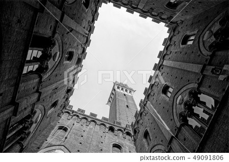 View from the courtyard of Siena town hall Palazzo Pubblico to Mangia Tower Torre del Mangia and View from the courtyard of Siena town hall Palazzo Pubblico to Mangia Tower Torre del Mangia and 49091806