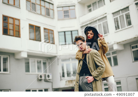 A trendy couple in a gloomy city A trendy couple in a gloomy city 49091807
