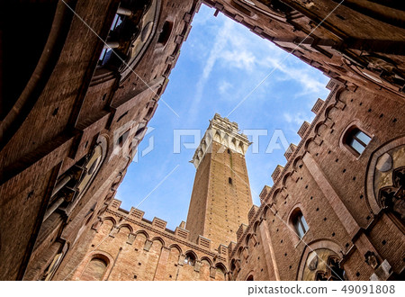 View from the courtyard of Siena town hall Palazzo Pubblico to Mangia Tower Torre del Mangia and View from the courtyard of Siena town hall Palazzo Pubblico to Mangia Tower Torre del Mangia and 49091808