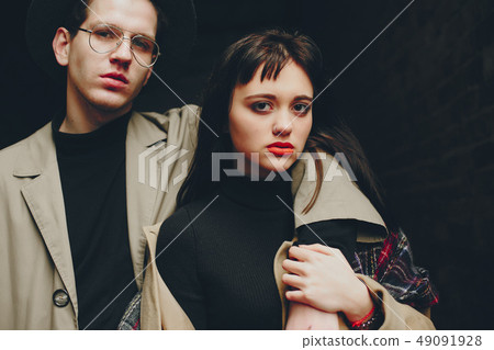 A trendy couple in a gloomy city A trendy couple in a gloomy city 49091928
