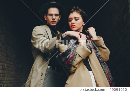 A trendy couple in a gloomy city A trendy couple in a gloomy city 49091930