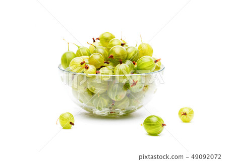 Photo of green gooseberry in glass cup on empty white background. Photo of green gooseberry in glass cup on empty white background. 49092072