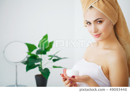 Beautiful girl in bathroom and mask for facial skin care Beautiful girl in bathroom and mask for facial skin care 49093448