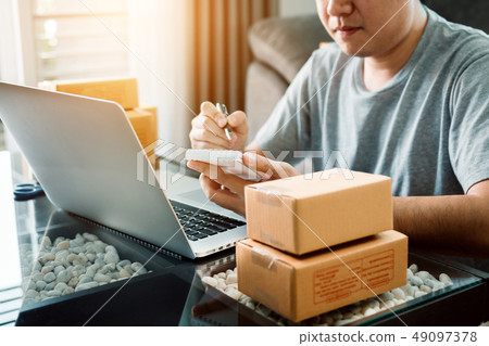 Young asian man looking on computer laptop and Young asian man looking on computer laptop and 49097378