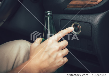 The man hand is holding a beer bottle and pressing The man hand is holding a beer bottle and pressing 49097384