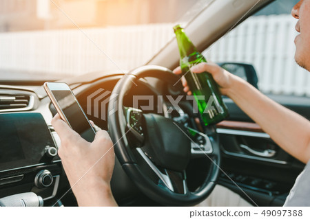 Asian men drink alcohol in the car and using Asian men drink alcohol in the car and using 49097388