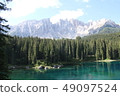 Lake Carezza and Dolomiti Massif and rocks and lake surface 49097524
