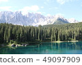 Lake surface reflections of Lake Carezza and the Dolomiti Massif 49097909