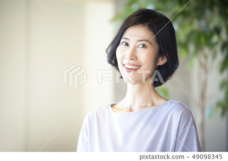 Female in her 50 49098345