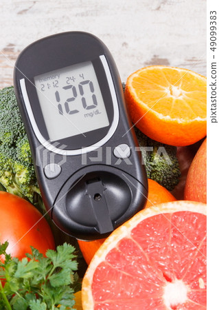Glucose meter with healthy fruits and vegetables 49099383