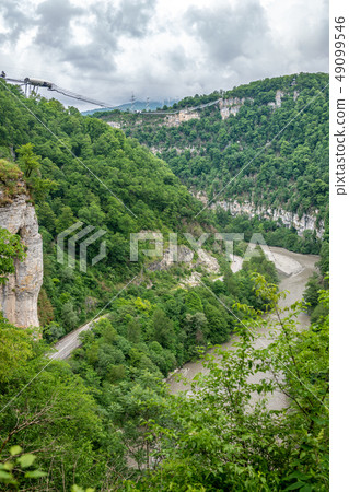 Skybridge suspension bridge over a gorge 49099546