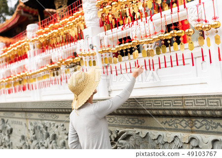 woman look at the golden bells 49103767
