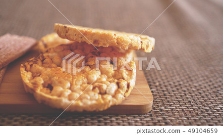 Composition with crunchy rice cakes on wooden background, side view - soft focus 49104659