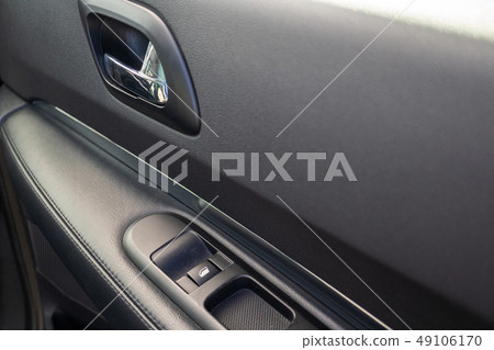 Car interior details of door handle with windows controls. Car window controls and details 49106170