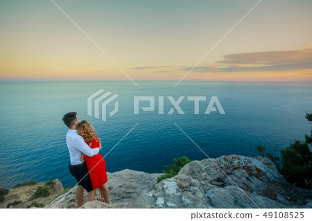 Couple family traveling together on cliff edge in Norway man and woman lifestyle concept summer Couple family traveling together on cliff edge in Norway man and woman lifestyle concept summer 49108525