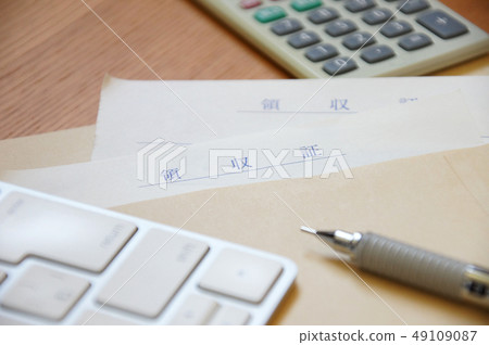 Receipt, calculator, keyboard and pen in an envelope Receipt, calculator, keyboard and pen in an envelope 49109087