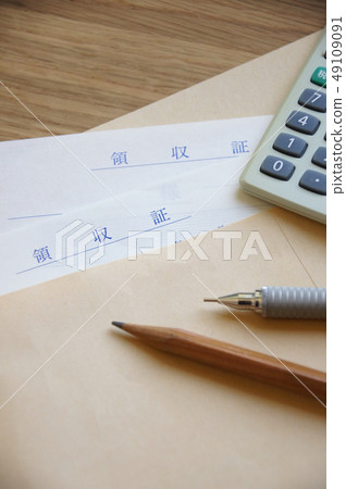Receipt and calculator and pen in an envelope 49109091