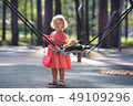 Sweet blond little baby girl in beautiful apricot 49109296