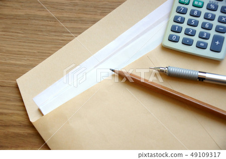 Documents, calculator and pen in A4 brown envelope Documents, calculator and pen in A4 brown envelope 49109317