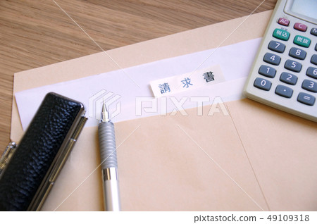 Bills and seals in a brown envelope on a desk and a pen and calculator Bills and seals in a brown envelope on a desk and a pen and calculator 49109318