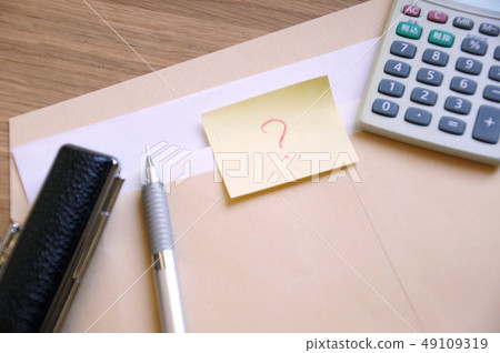 A note with a document and an ending mark written in a brown envelope, a seal, a pen and a calculator A note with a document and an ending mark written in a brown envelope, a seal, a pen and a calculator 49109319
