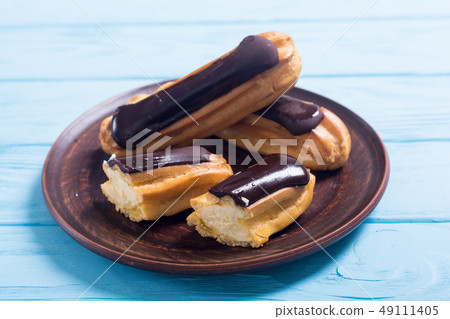 French dessert eclair with chocolate . 49111405