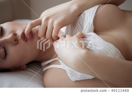 Attractive sensual woman in lingerie on bed in Attractive sensual woman in lingerie on bed in 49111489