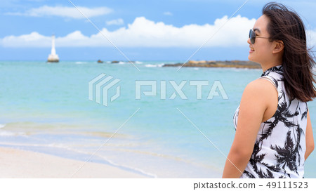 Beautiful woman tourist on the beach in Thailand Beautiful woman tourist on the beach in Thailand 49111523