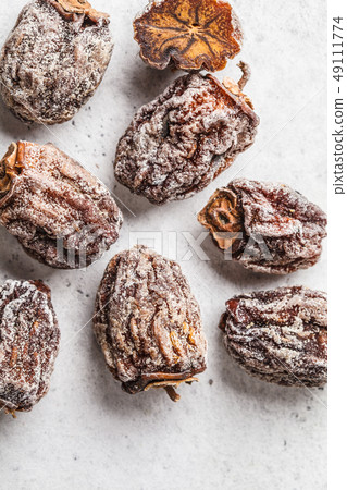 Dried sweet persimmon on a white background. 49111774
