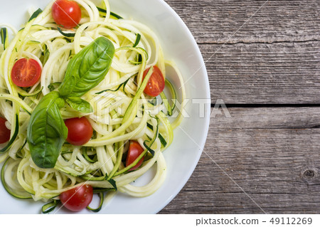 Zucchini pasta noodles with tomatoes . Healthy 49112269