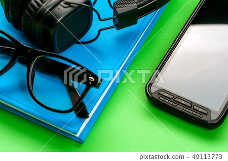 Black stylish headphones on green background. 49113773