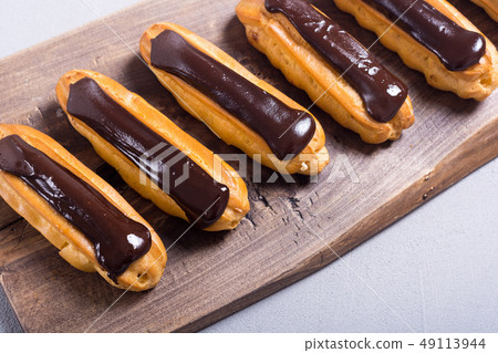 French dessert eclair with chocolate . 49113944