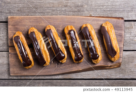 French dessert eclair with chocolate . 49113945