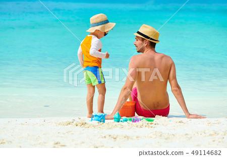 Toddler boy on beach with father 49114682