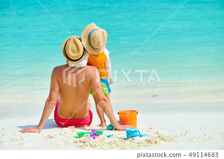 Toddler boy on beach with father 49114683