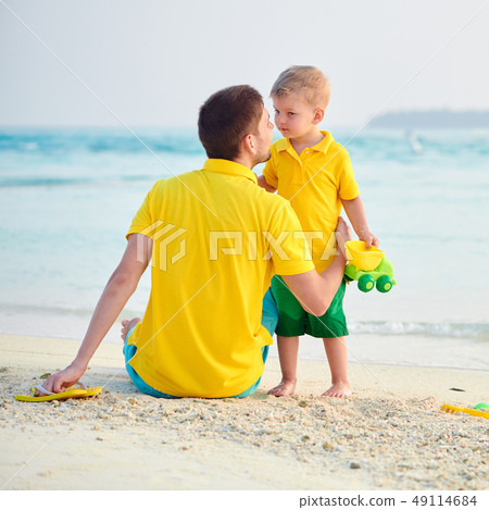 Toddler boy on beach with father 49114684