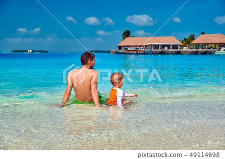 Toddler boy on beach with father 49114698