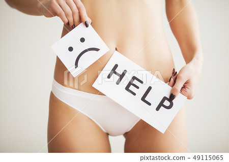 Woman Health Problem. Closeup Of Female With Fit Slim Body In Panties Holding White Card With Sad 49115065