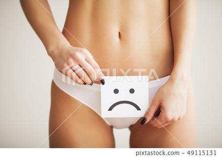 Woman Health Problem. Closeup Of Female With Fit Slim Body In Panties Holding White Card With Sad 49115131