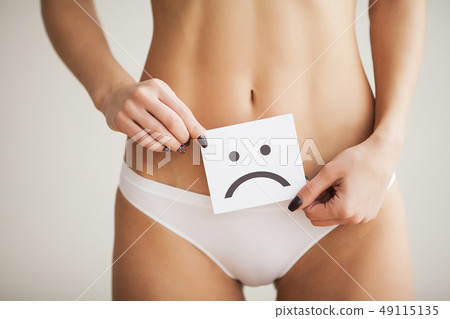 Woman Health Problem. Closeup Of Female With Fit Slim Body In Panties Holding White Card With Sad 49115135