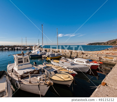 Boats moored in a small harbor in the Gulf of 49115212